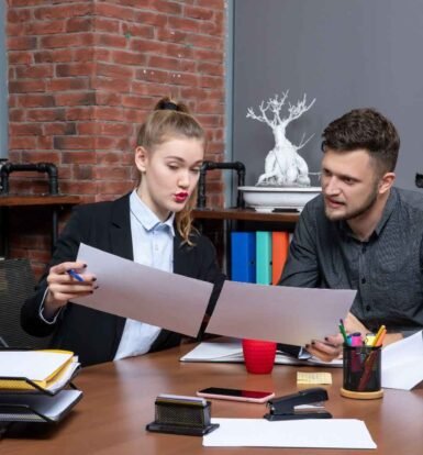 Law firm professionals reviewing documents—how Virtual Legal Assistants help cut costs and improve efficiency.
