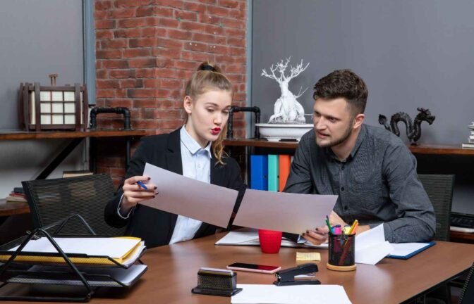 Law firm professionals reviewing documents—how Virtual Legal Assistants help cut costs and improve efficiency.