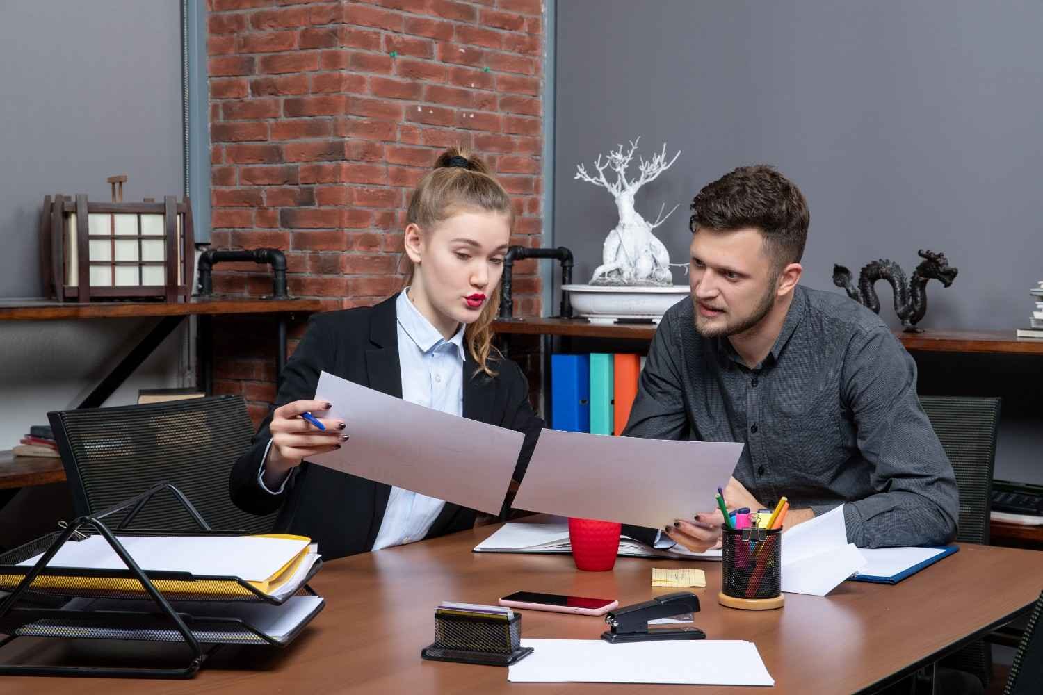 Law firm professionals reviewing documents—how Virtual Legal Assistants help cut costs and improve efficiency.