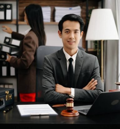 Confident immigration attorney in office with legal assistant organizing case files, symbolizing law firm efficiency and growth.