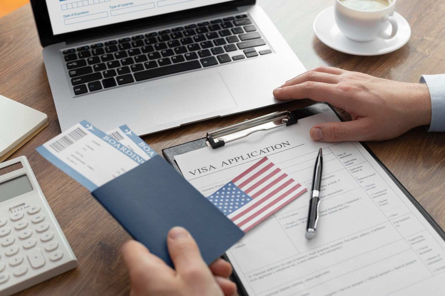 Visa application and supporting documents on a desk—ensuring H-1B petition signature requirements are met for USCIS compliance.