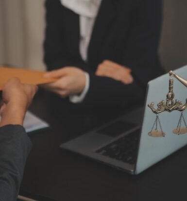 Immigration attorney receiving documents from a client with legal scales in the foreground