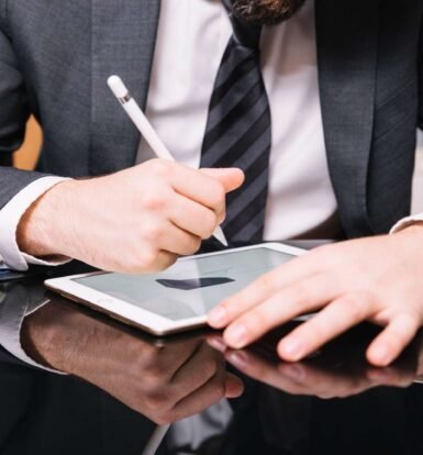 Immigration attorney using a tablet and stylus to review and organize documents with the help of virtual paralegals for USCIS petition submissions.