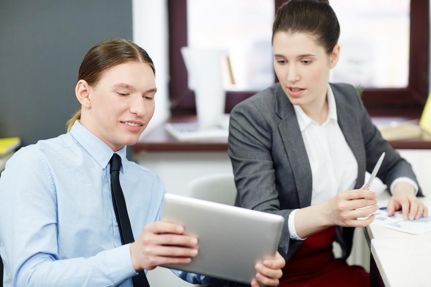 Virtual paralegals discussing immigration case management software on a tablet.