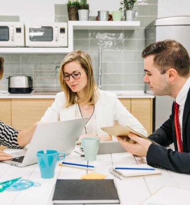 Immigration law firm team discussing client communication strategies with digital tools, improving workflow efficiency and client satisfaction.