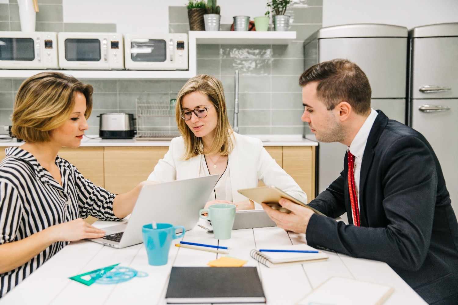 Immigration law firm team discussing client communication strategies with digital tools, improving workflow efficiency and client satisfaction.