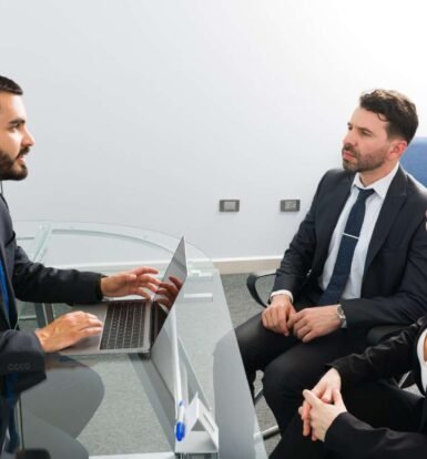 Immigration attorney discussing case details with clients in a meeting