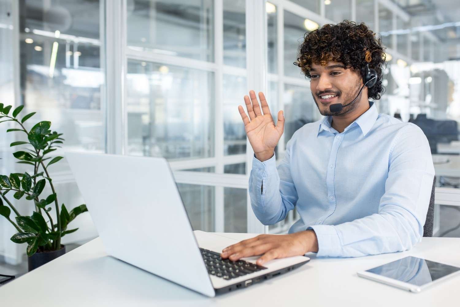 Virtual paralegal assisting with immigration filings, using a laptop and headset to manage proof of business documents.