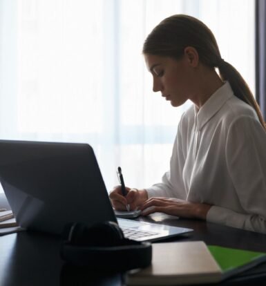 A virtual paralegal tracking USCIS processing times on a laptop.