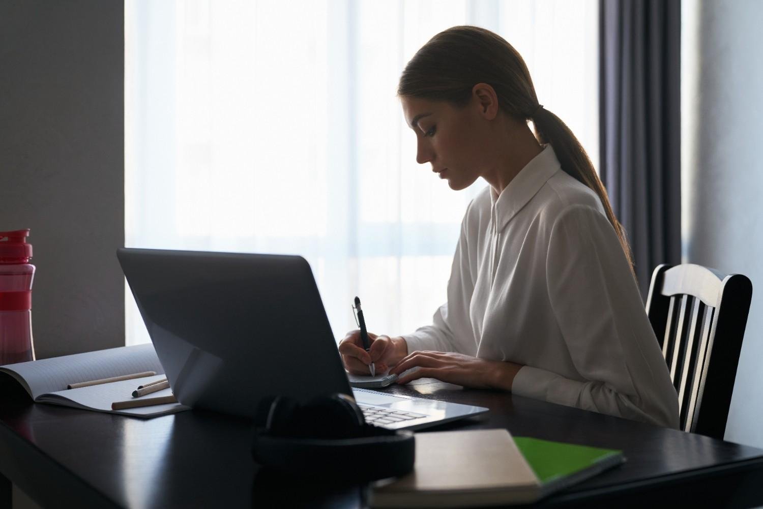 A virtual paralegal tracking USCIS processing times on a laptop.