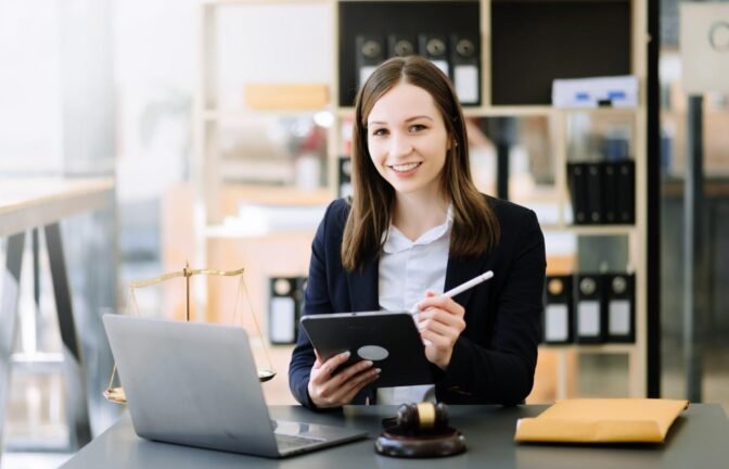 Smiling legal professional using a tablet and AI-powered tools to streamline law firm workflows in a modern office setting.