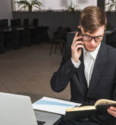 A professional working in an office with a virtual legal assistant setup, using a laptop and phone to manage cross-border cases.