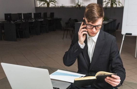 A professional working in an office with a virtual legal assistant setup, using a laptop and phone to manage cross-border cases.