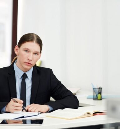 Legal professional working at a desk, organizing case files and documents to improve law firm efficiency.