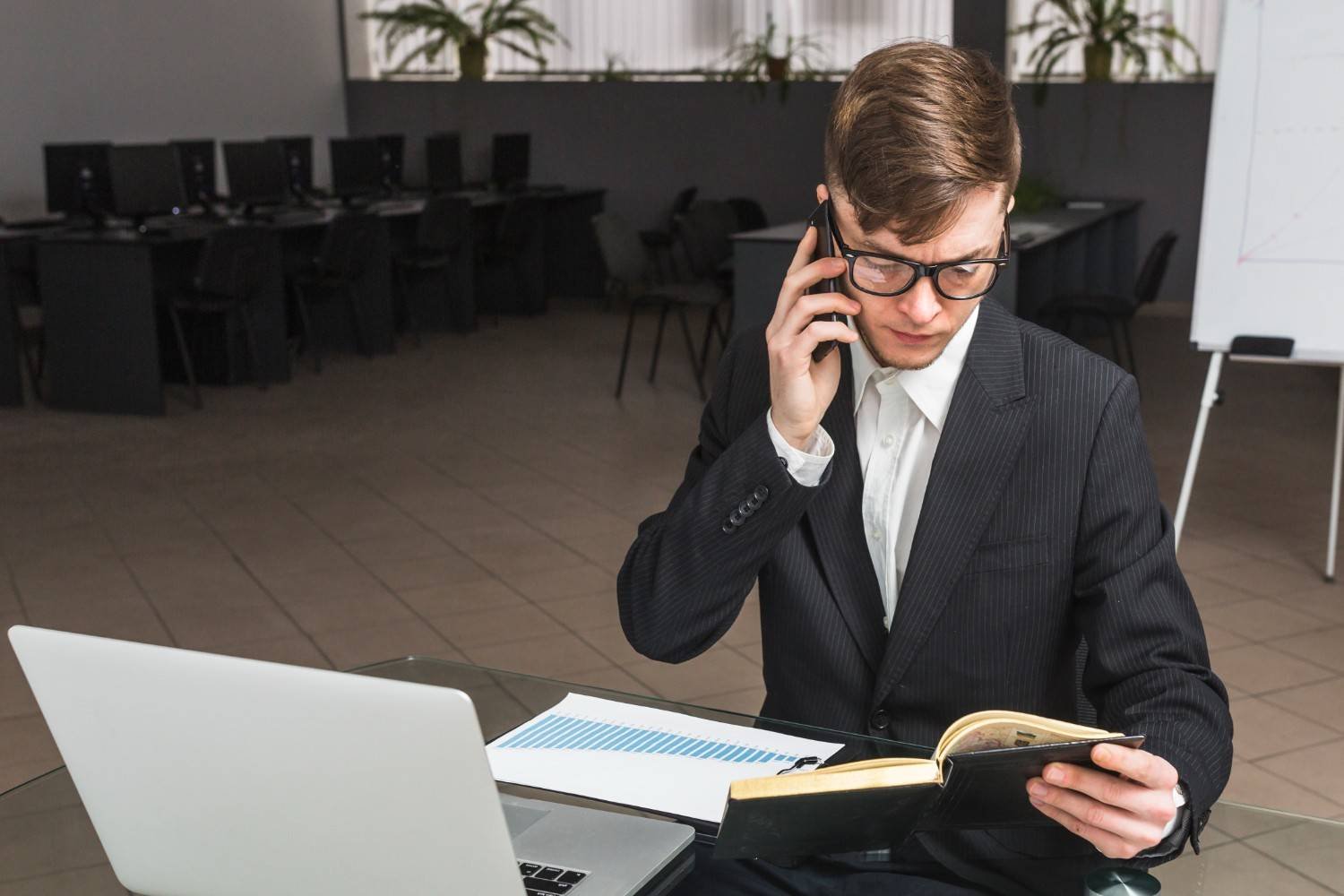 Attorney using virtual assistant services while reviewing documents and speaking on the phone.