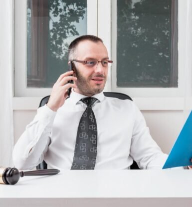 Immigration attorney reviewing H-4 visa application documents while on a call.