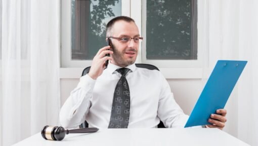 Immigration attorney reviewing H-4 visa application documents while on a call.